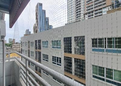 View of modern buildings from a balcony with safety netting