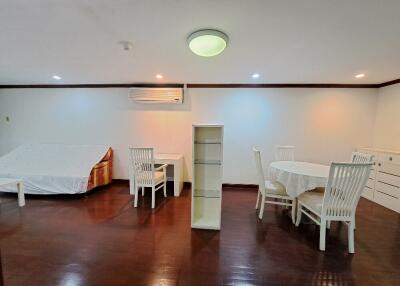 A well-lit living room with dining area and additional seating