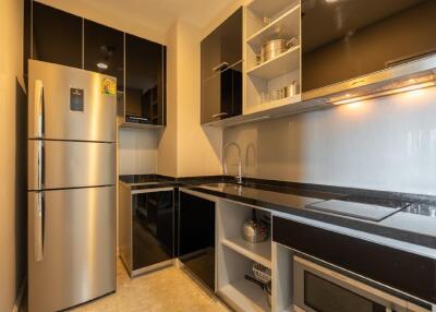 Modern kitchen with black cabinets and stainless steel appliances