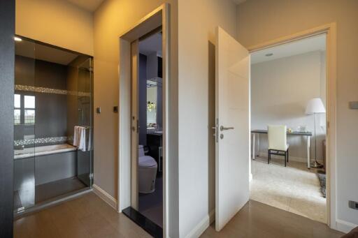 View of a house interior showing a bathroom, shower area, and a study room