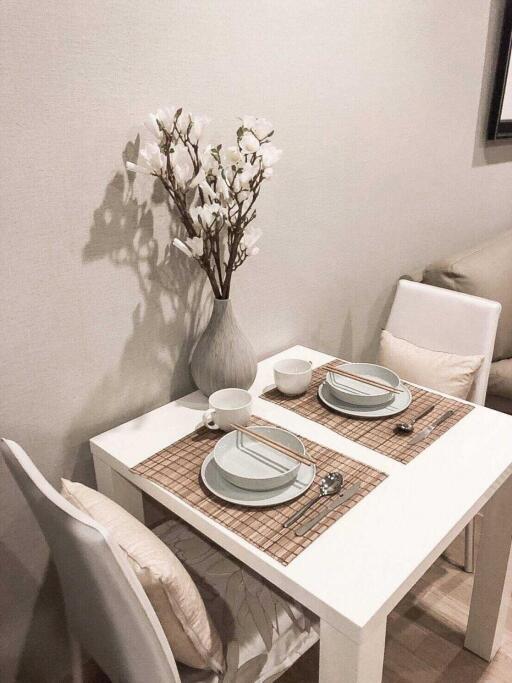 Cozy small dining area with white table and chairs