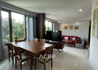 Spacious living room with dining area and large windows