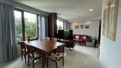 Spacious living room with dining area and large windows