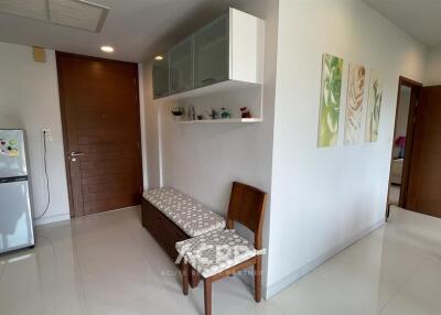 A bright hallway with a bench and wall art