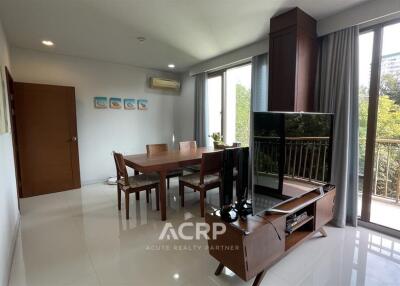 Living and dining area with large windows and modern furniture