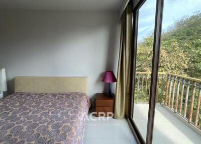 Bedroom with Balcony and Large Window