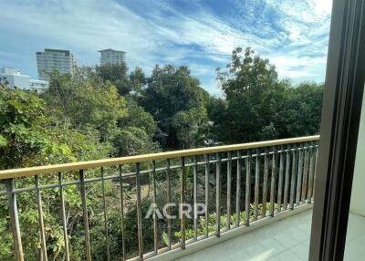 Balcony with a view of trees and buildings