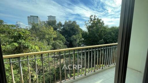 Balcony with a view of trees and buildings