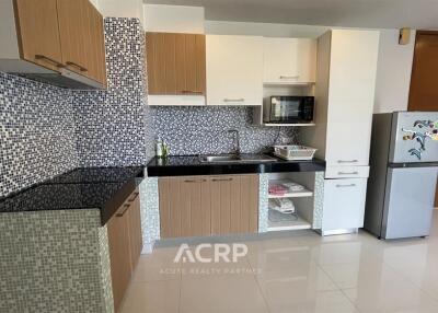 Modern kitchen with mosaic tile backsplash and wooden cabinets