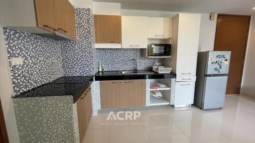 Modern kitchen with mosaic tile backsplash and wooden cabinets