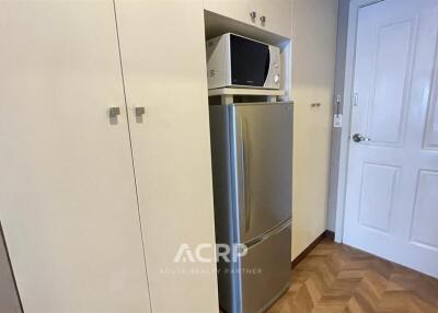 Compact kitchen area with microwave and refrigerator