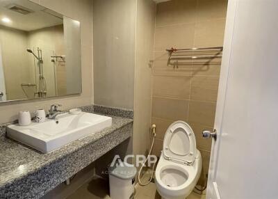 Modern bathroom with granite countertop and large mirror