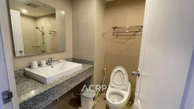 Modern bathroom with granite countertop and large mirror