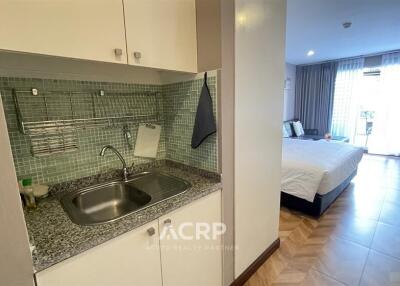 Studio apartment with kitchenette and bed area