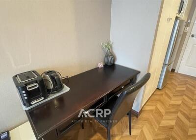 Modern kitchen area with appliances and dining space