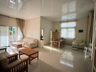 Spacious living room with large windows and modern furniture