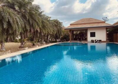 Outdoor area with a large pool and adjacent building