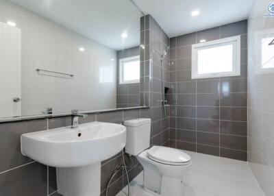 Modern bathroom with sink, toilet, and shower area