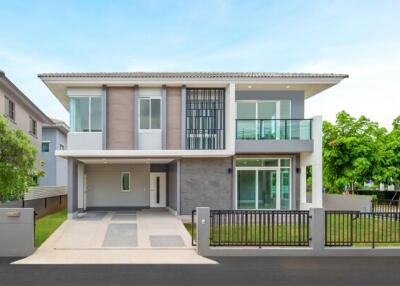 Two-story modern house with driveway and front yard