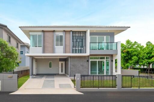 Two-story modern house with driveway and front yard