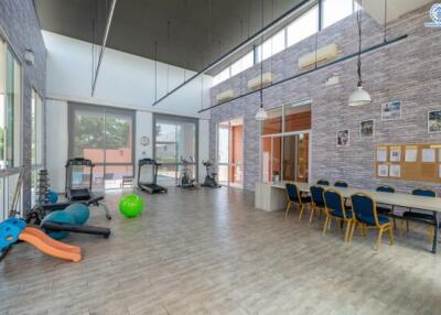 Multipurpose room with gym equipment and dining area