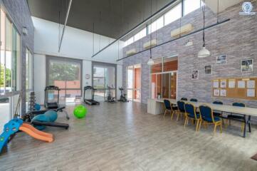 Multipurpose room with gym equipment and dining area