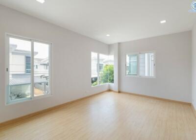 Spacious empty bedroom with large windows