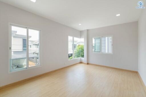 Spacious empty bedroom with large windows