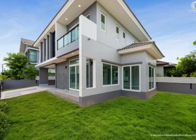 Modern two-story house exterior with green lawn