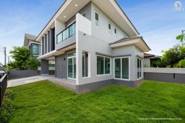 Modern two-story house exterior with green lawn