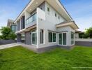 Modern two-story house exterior with green lawn