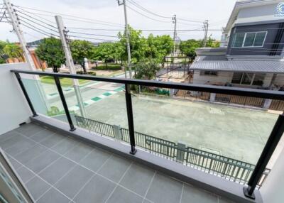 Modern balcony with glass railing and street view