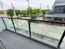 Modern balcony with glass railing and street view