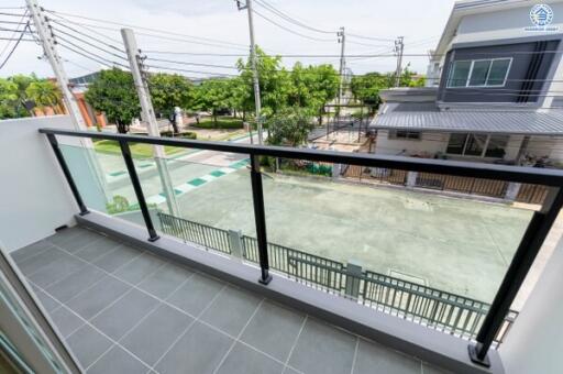 Modern balcony with glass railing and street view