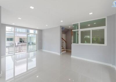 spacious living area with large windows and modern tile flooring