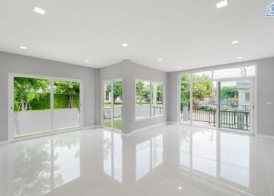 Spacious living room with large windows and bright lighting