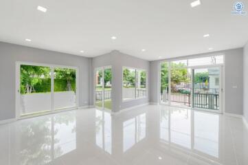 Spacious living room with large windows and bright lighting