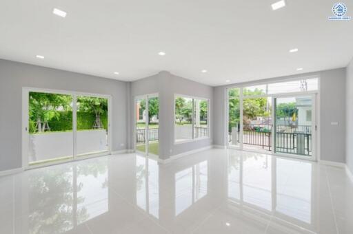 Spacious living room with large windows and bright lighting