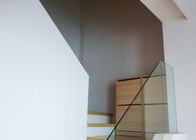 Modern staircase with wooden steps and glass railing