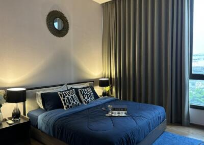 Modern bedroom with blue bedding and wooden flooring