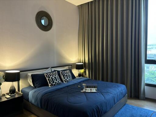 Modern bedroom with blue bedding and wooden flooring