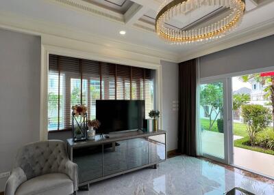 Elegant living room with chandelier and TV