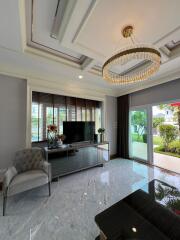 Elegant living room with chandelier and TV