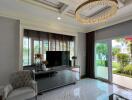 Elegant living room with chandelier and TV