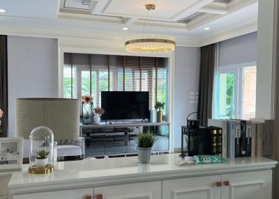 Modern living room with chandelier and large windows