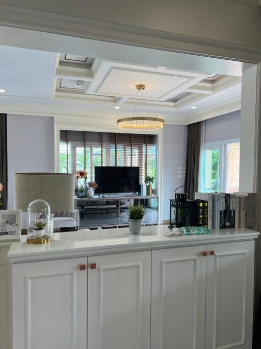 Modern living room with chandelier and large windows