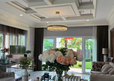 Elegant living room with chandelier and floral arrangement