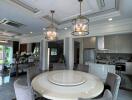 Dining area with round table and chairs, adjacent to open modern kitchen