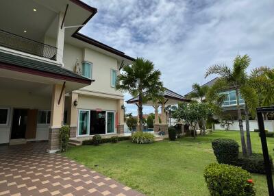 Exterior view of a house with a tiled walkway and garden