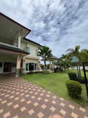 Exterior view of a house with a tiled walkway and garden